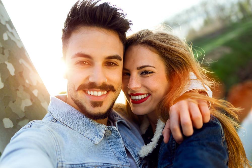 Happy couple take a selfie after teeth whitening at Dental Solutions