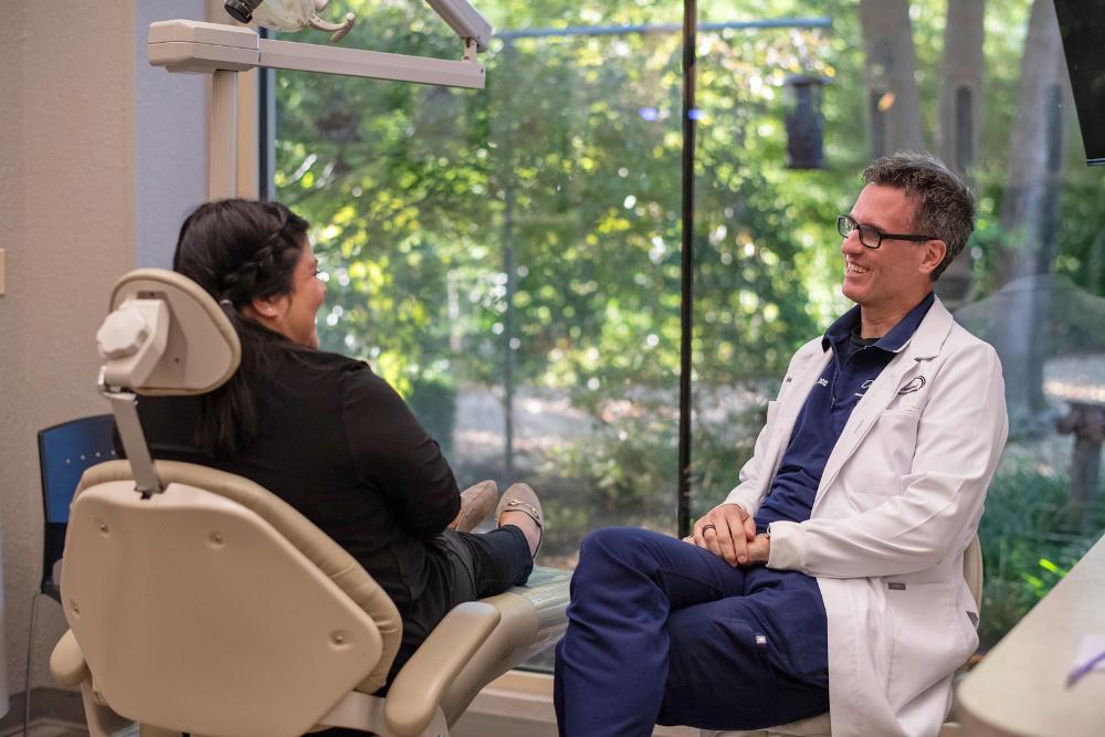 smiling older couple taking a selfie at a dinner table