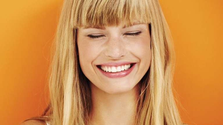 Lady smiling after professional teeth whitening at Dental Solutions, Jonesboro, AR