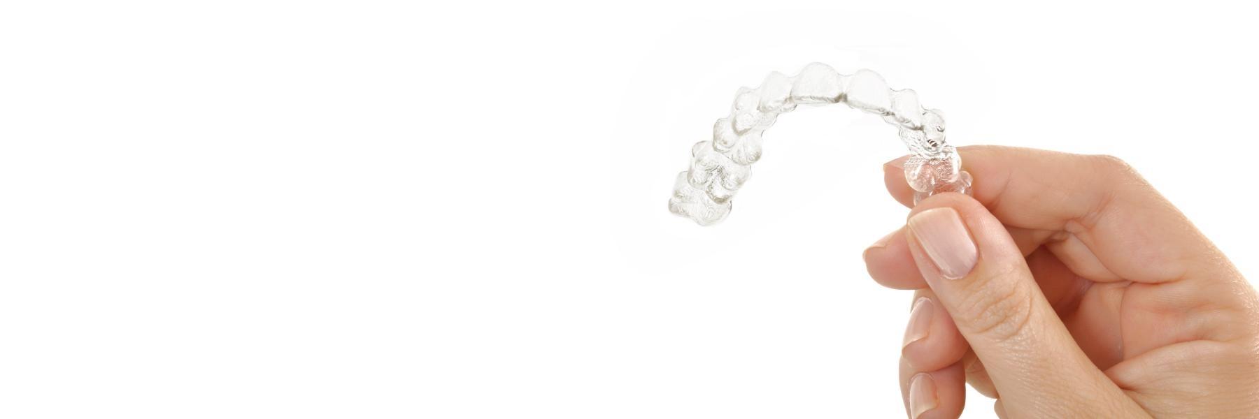 close up of woman's hand holding Invisalign