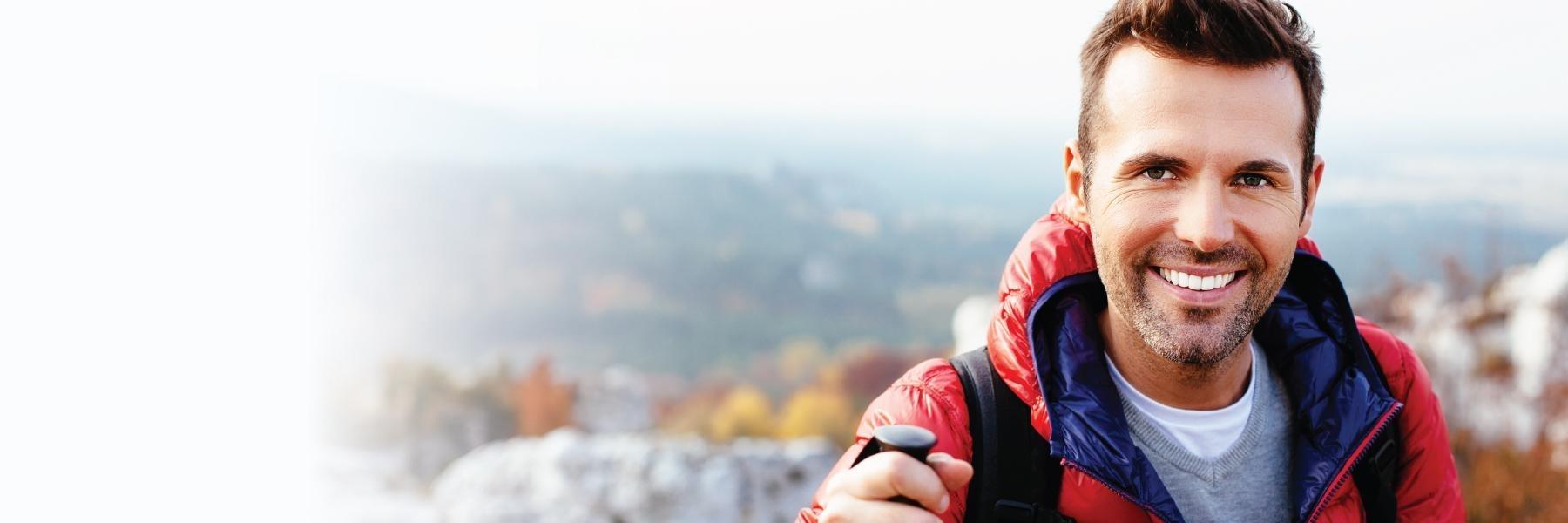 man smiling with red jacket